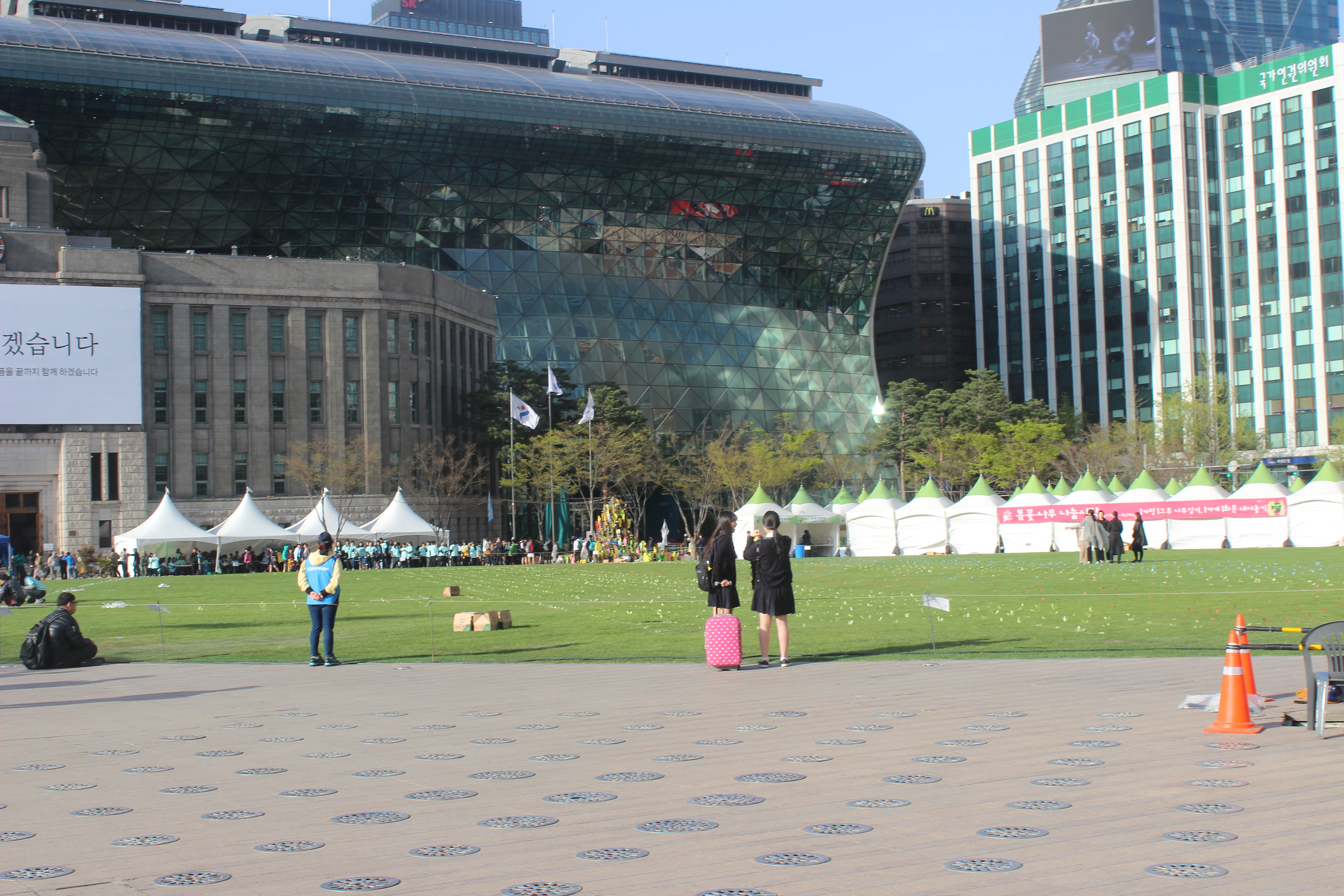 The organizers marked out on the grass the shape of the ferry itself. The participants sat on an imagined ferry right there in downtown Seoul. 